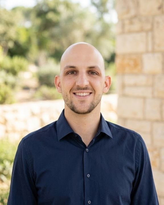Portrait of Lucas Jeune, smiling, wearing a navy shirt